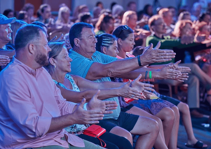 Audience reaching forward and clapping