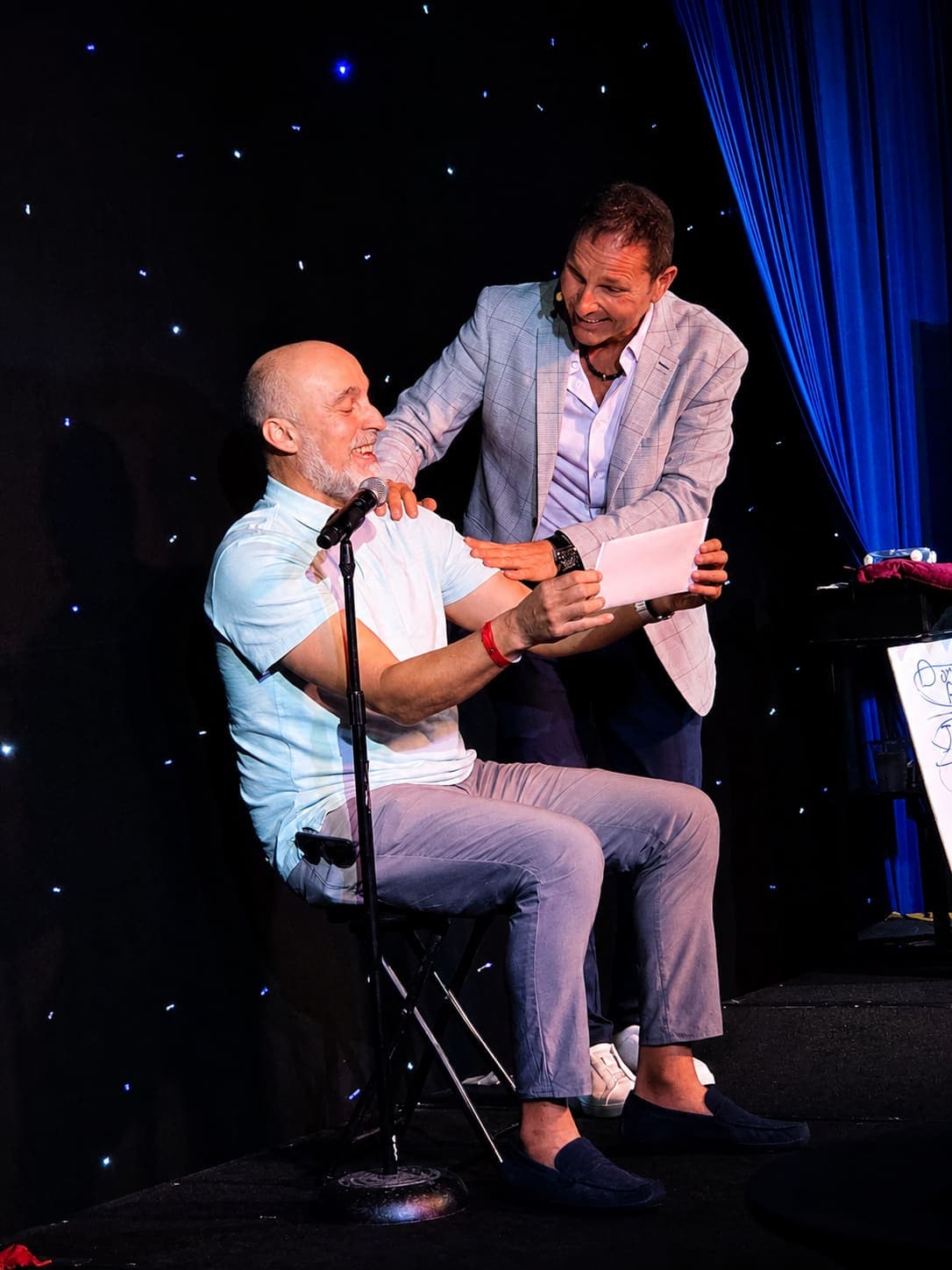 Guy Bavli revealing a prediction live on stage