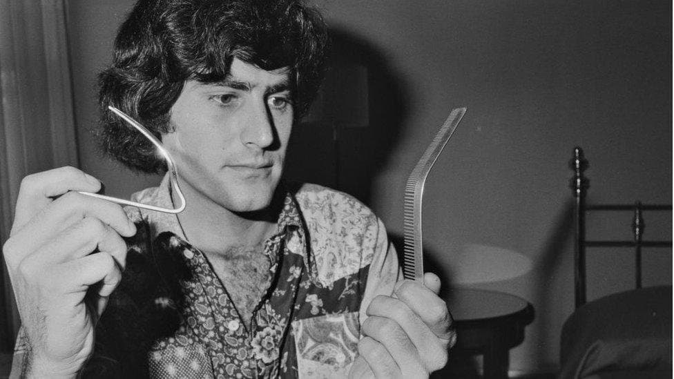 Uri Geller bending a spoon