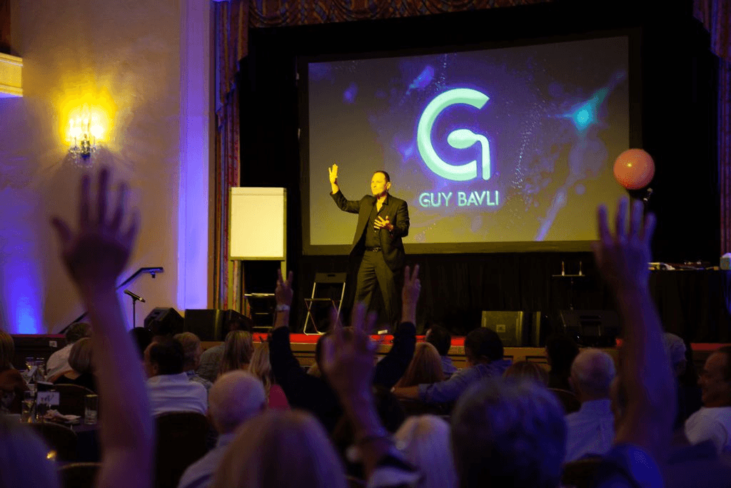 Guy Bavli on stage in front of a corporate audience